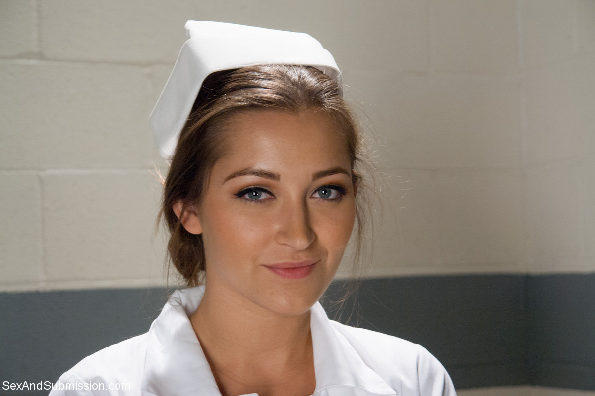 Gorgeous nurse with a nice butt Dani Daniels strips and poses in high heels