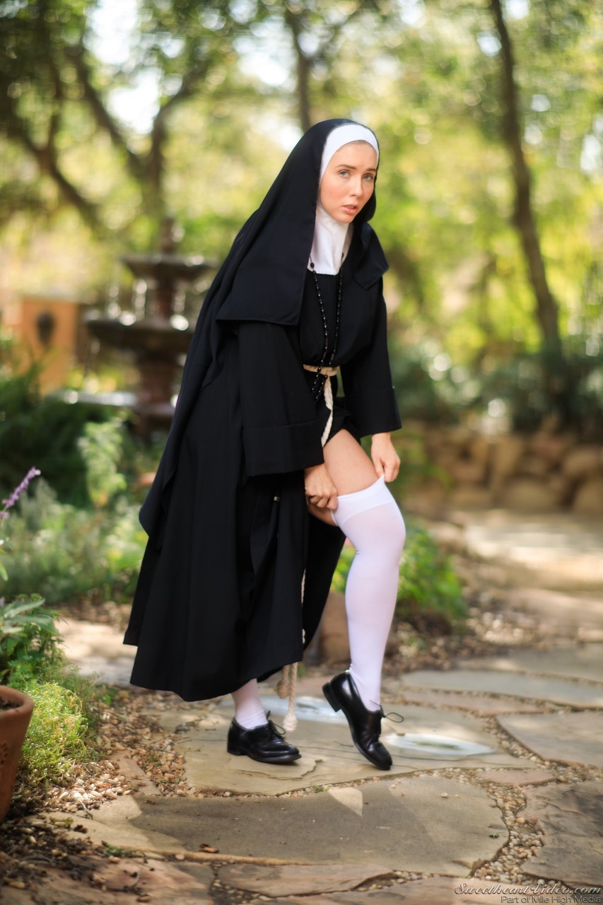 Thick Nun exposes herself in the courtyard wearing over the knee socks