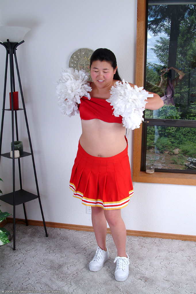 Chubby Asian first timer baring small boobs while shedding cheer uniform