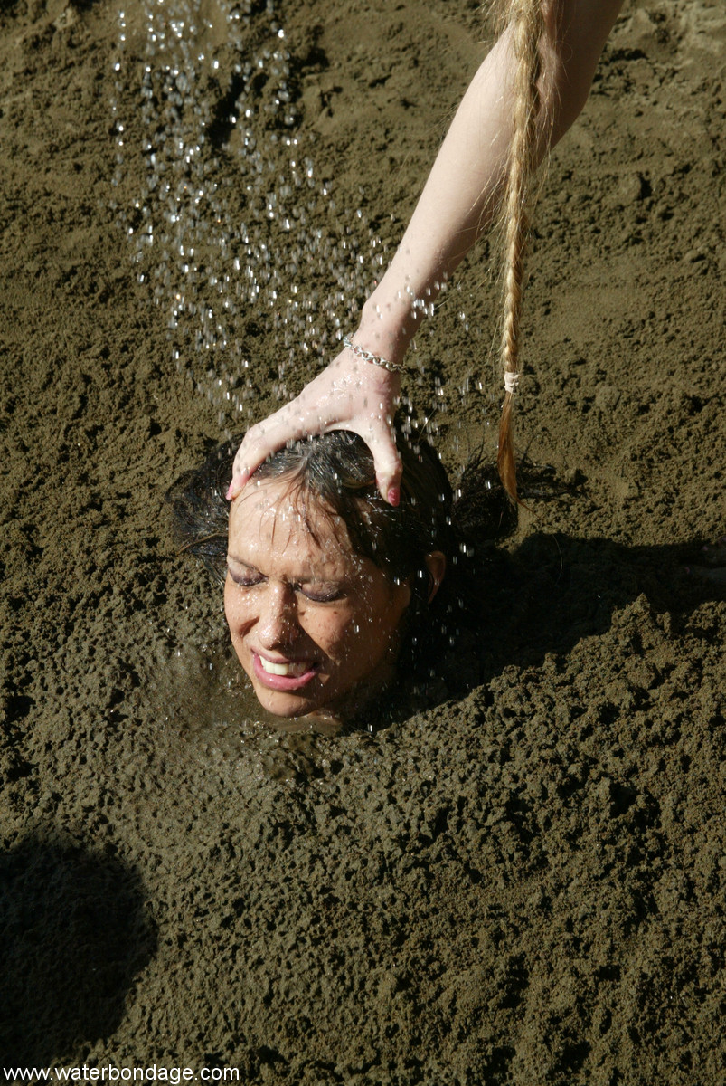 Bound slut with big boobs Sasha Sparks gets buried in mud by her lezdom