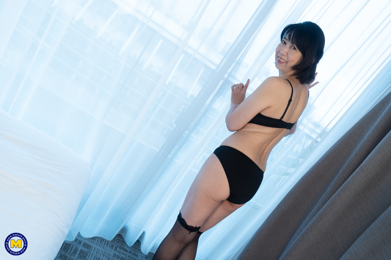 Mature Japanese lady Yoshiko Kitano shows off her petite body in stockings