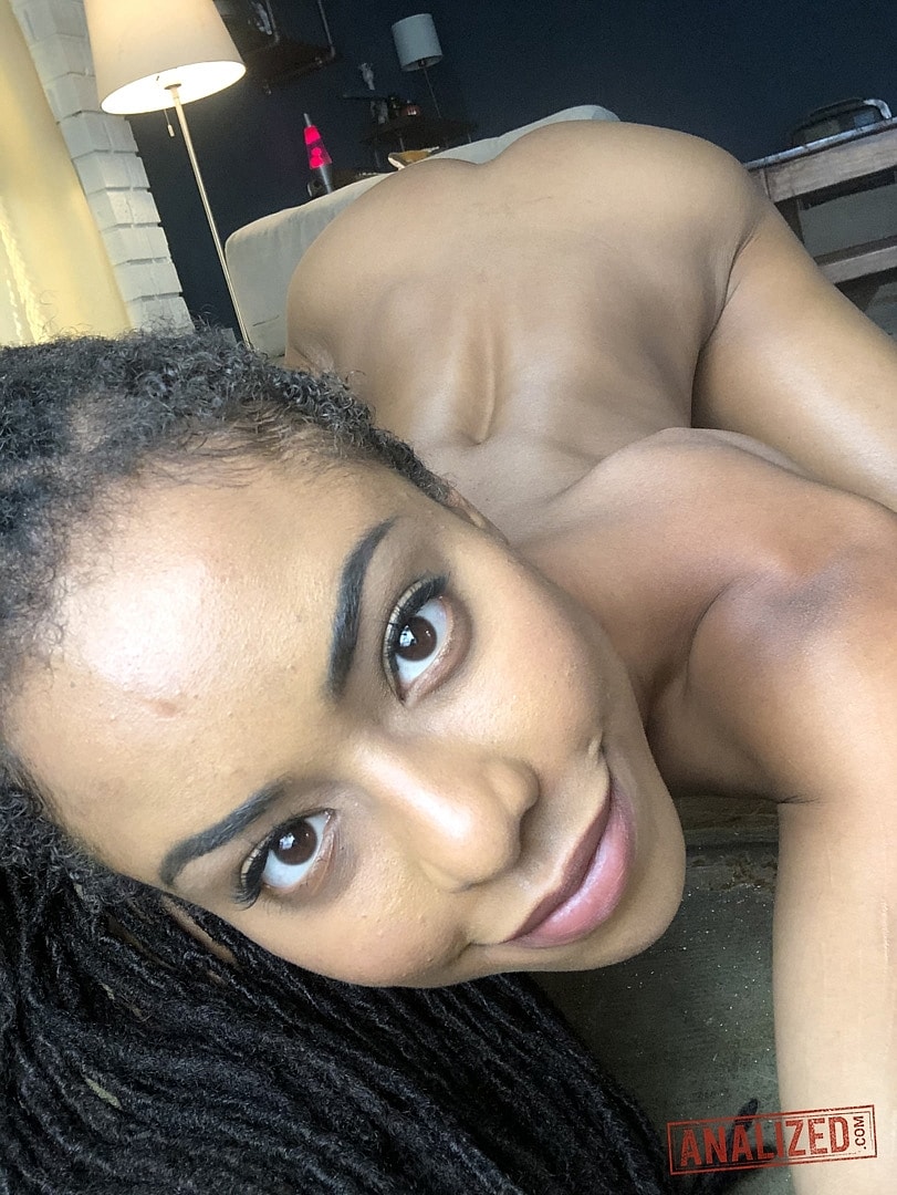 Ebony girl Kira Noir teases with her small bum and tiny tits in a solo