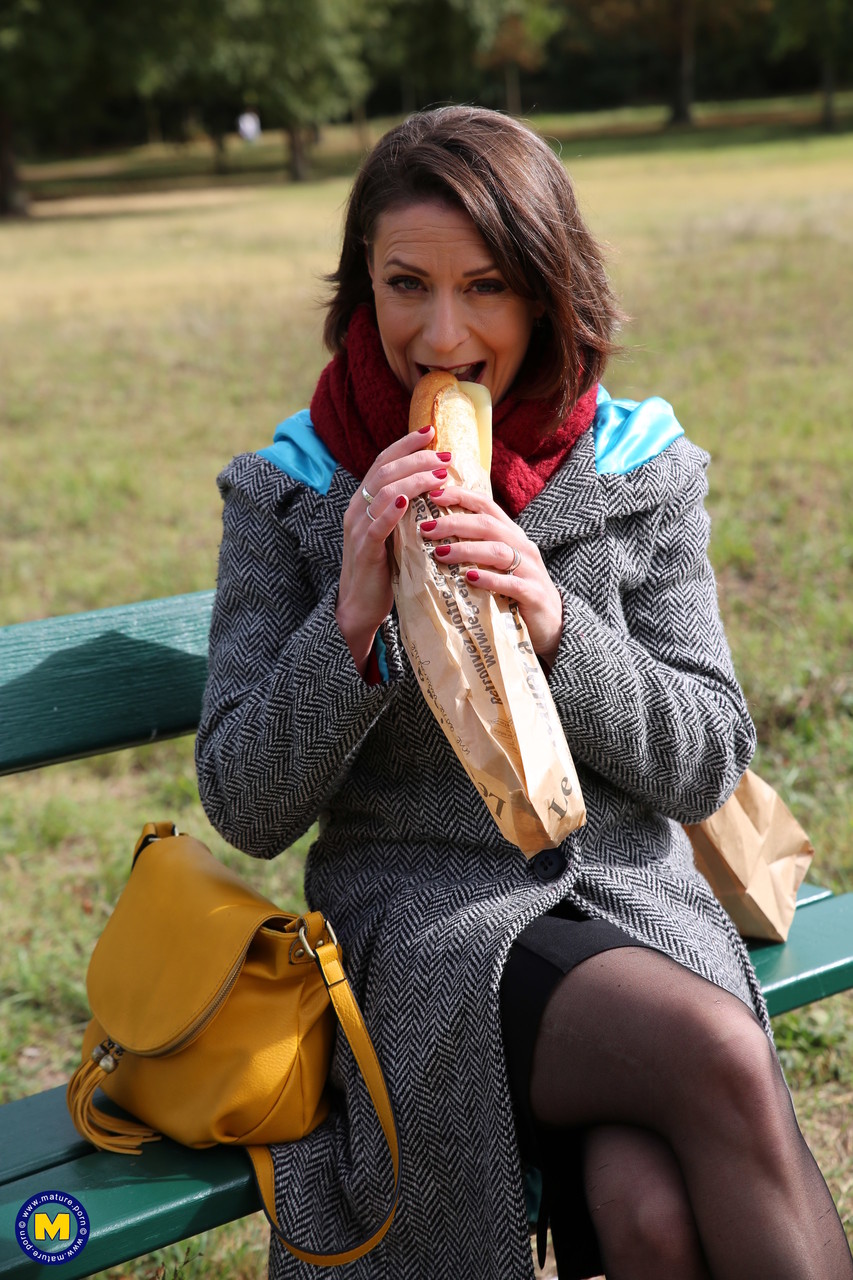 French mom Anya flashes her legs in stockings while eating a sandwich outside