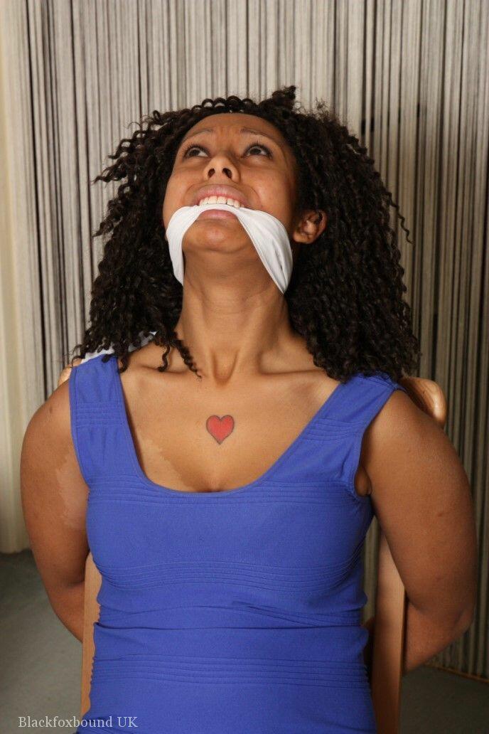 Black girl Dani is cleave gagged while hogtied in a short dress and footwear