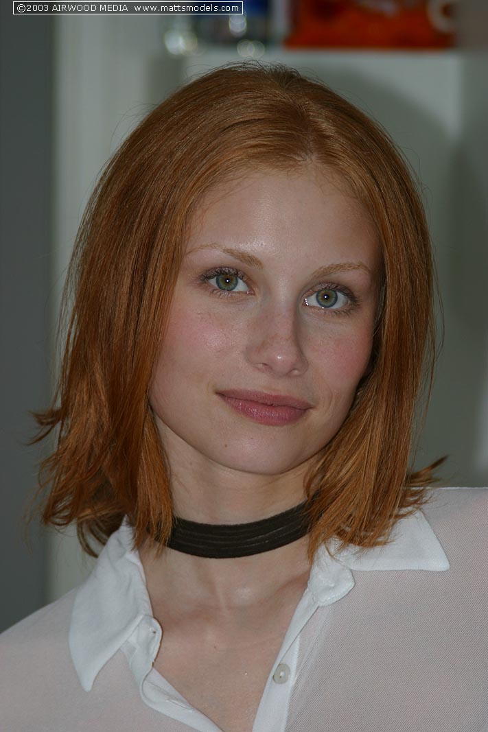 Pale redhead Anya poses naked on kitchen counter in a black choker