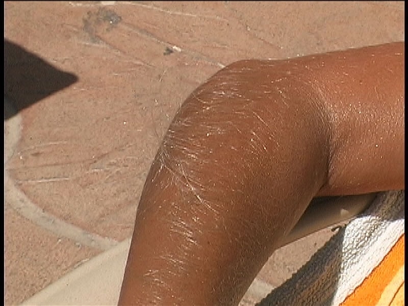 Beautiful tanned Lori Anderson teases with her hairy arms while sunbathing