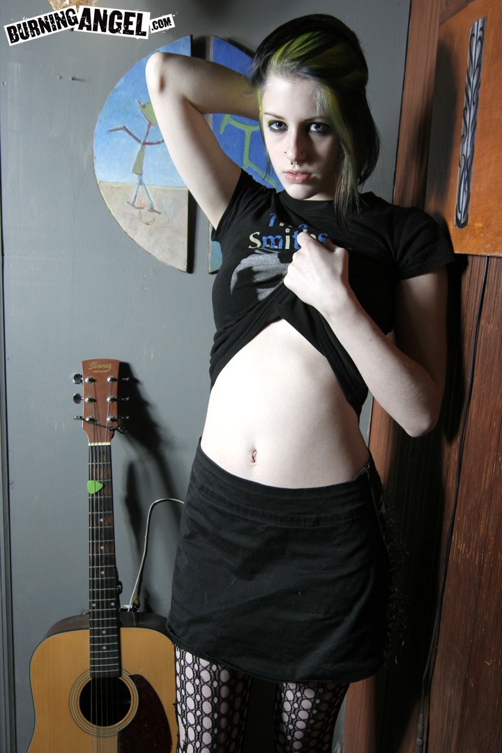 Goth misfit Rubella loses her clothes to display her soft body and perky tits