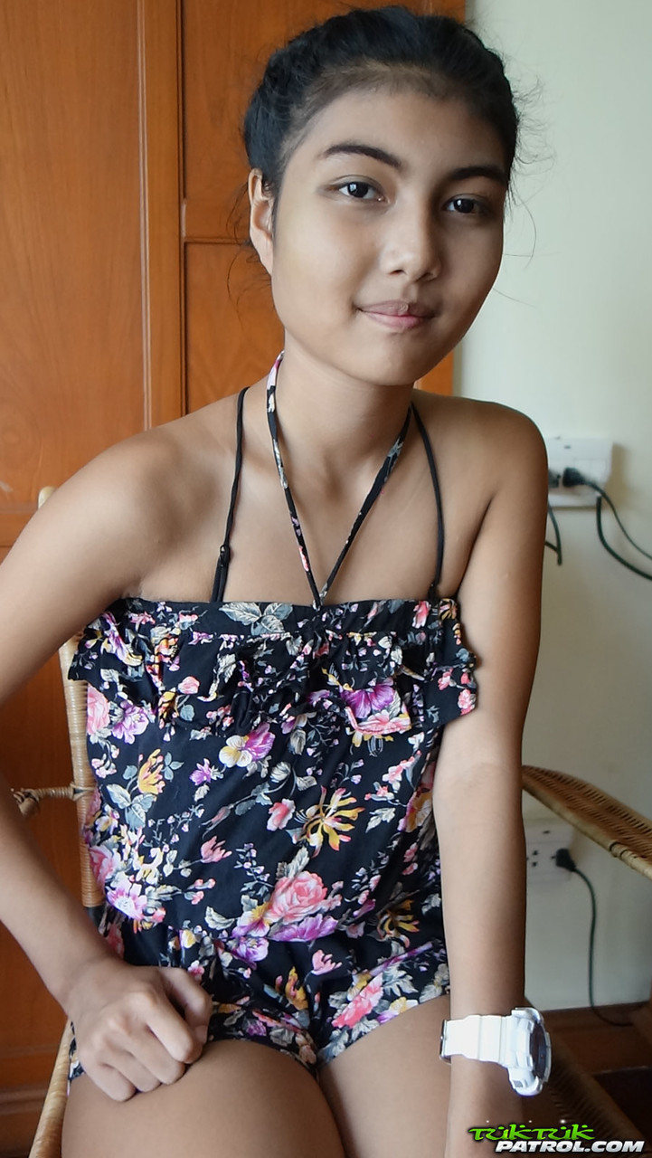 Petite Asian teen Pauw takes off her gown and flaunts her tits and hairy kitty