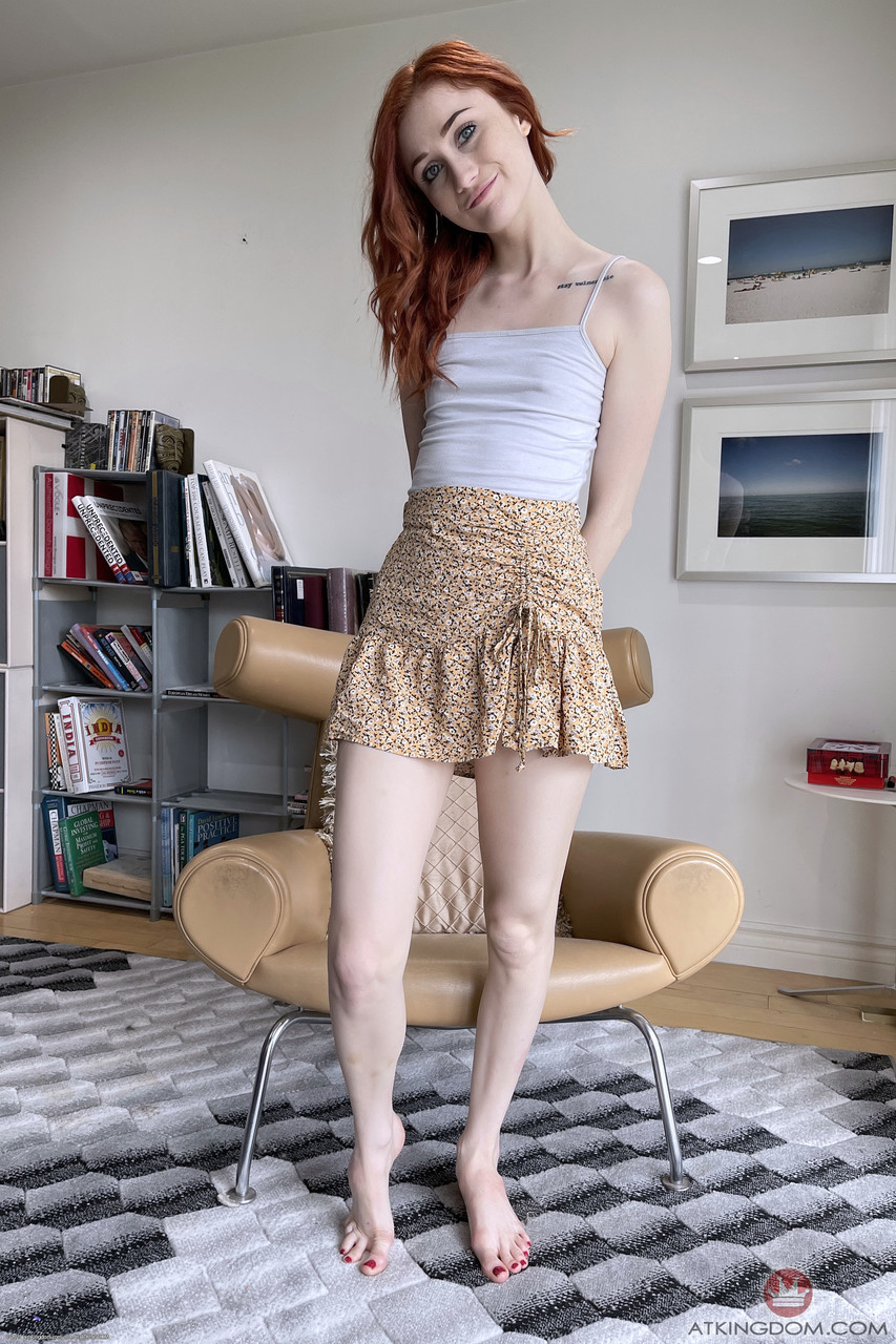 Redheaded teen with a tasty hole Scarlet Skies lifts her skirt up and poses