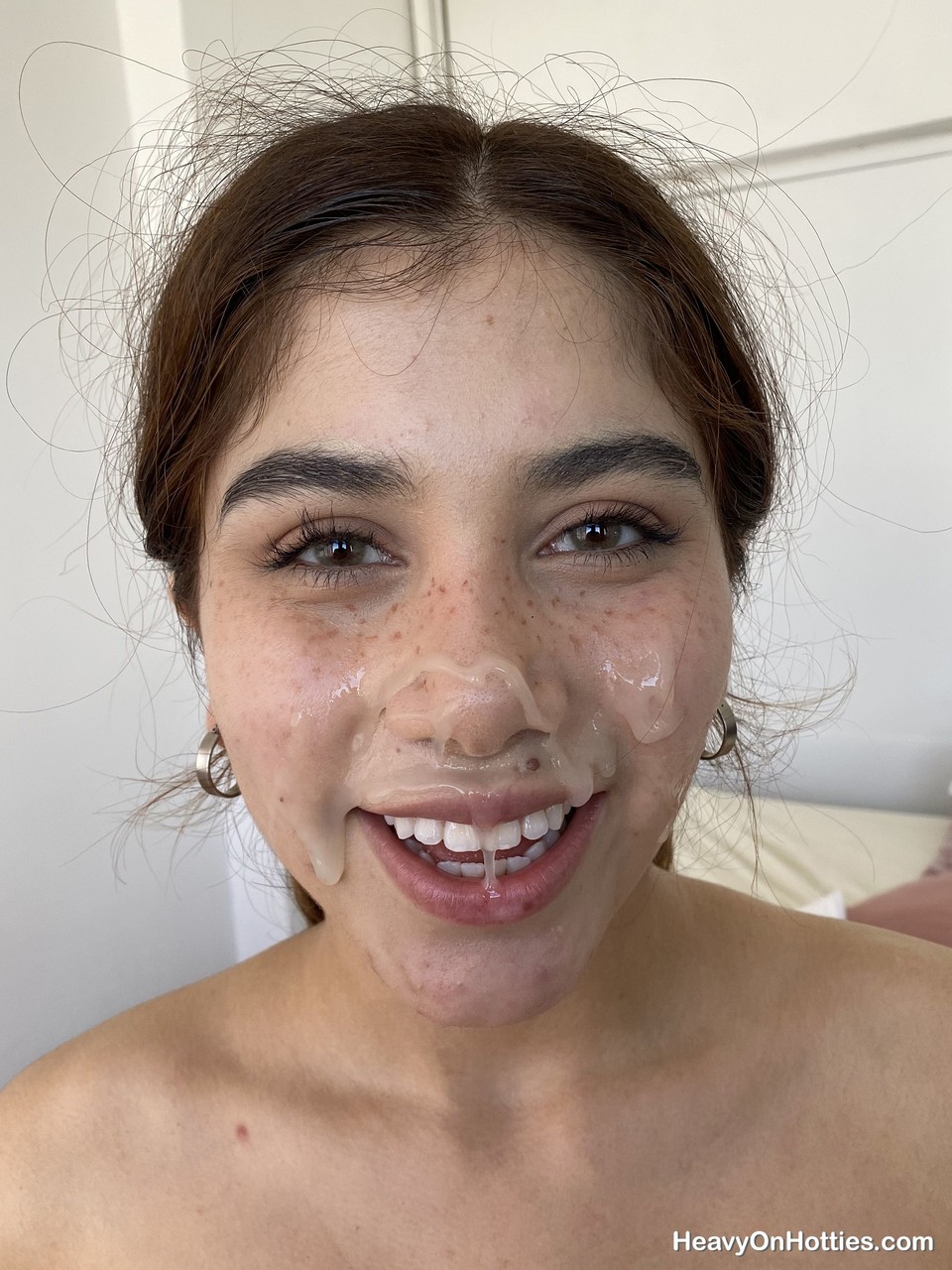 Young amateur takes a cumshot on her freckled face during POV action